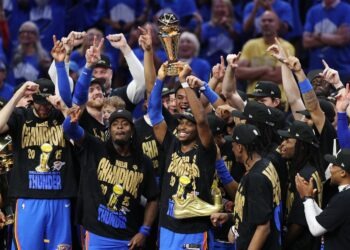 OKLAHOMA CITY, OKLAHOMA - JUNE 22:  Shai Gilgeous-Alexander #2 of the Oklahoma City Thunder celebrates with the Bill Russell NBA Finals Most Valuable Player trophy after defeating the Indiana Pacers 103-91 in Game Seven of the 2025 NBA Finals at Paycom Center on June 22, 2025 in Oklahoma City, Oklahoma. NOTE TO USER: User expressly acknowledges and agrees that, by downloading and or using this photograph, User is consenting to the terms and conditions of the Getty Images License Agreement. (Photo by Justin Ford/Getty Images)