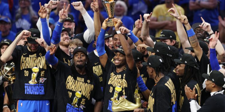 OKLAHOMA CITY, OKLAHOMA - JUNE 22:  Shai Gilgeous-Alexander #2 of the Oklahoma City Thunder celebrates with the Bill Russell NBA Finals Most Valuable Player trophy after defeating the Indiana Pacers 103-91 in Game Seven of the 2025 NBA Finals at Paycom Center on June 22, 2025 in Oklahoma City, Oklahoma. NOTE TO USER: User expressly acknowledges and agrees that, by downloading and or using this photograph, User is consenting to the terms and conditions of the Getty Images License Agreement. (Photo by Justin Ford/Getty Images)