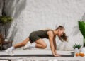Athletic woman performing mountain climbers during HIIT workout at home outdoor gym functional training for healthy lifestyle