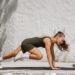 Athletic woman performing mountain climbers during HIIT workout at home outdoor gym functional training for healthy lifestyle