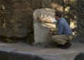 Tom Hiddleston examines an inscription at the Gatehouse ruins in Pompeii. (National Geographic/Paolo Verzone)