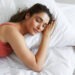 Top view of beautiful young woman sleeping while lying in bed