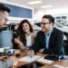 Middle age couple choosing and buying car at car showroom. Car salesman helps them to make right decision. Man signs buyers contract.