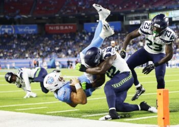 NASHVILLE, TENNESSEE - AUGUST 23: Will Levis #8 of the Tennessee Titans is tackled by D'Anthony Bell #23 and Aaron Smith #42 of the Seattle Seahawks during the second half of Week 2 of the preseason game at Nissan Stadium on August 23, 2026 in Nashville, Tennessee. (Photo by Johnnie Izquierdo/Getty Images)