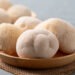 Fresh Lion's Mane mushroom,(Hericium erinaceus) on a wooden plate, known for nootropic benefits and medicinal properties